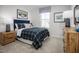 Cozy bedroom featuring a plaid comforter, side tables, and a natural light filled window at 133 Cavalier Rider Run, Wendell, NC 27591