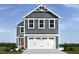 Charming two-story home with gray siding and a spacious two-car garage at 133 Cavalier Rider Run, Wendell, NC 27591