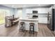 Eat-in kitchen featuring stainless steel appliances, white cabinetry, and a center island with seating at 133 Cavalier Rider Run, Wendell, NC 27591