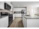 Bright kitchen with stainless steel appliances, granite counters, and wood-look flooring at 133 Cavalier Rider Run, Wendell, NC 27591