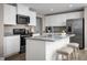 Modern kitchen featuring white cabinets, stainless steel appliances, and granite countertops at 133 Cavalier Rider Run, Wendell, NC 27591