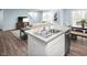 Open concept kitchen with a breakfast bar flowing into the living and dining areas at 133 Cavalier Rider Run, Wendell, NC 27591