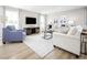 Cozy living room with a large window, comfortable seating, and contemporary decor at 133 Cavalier Rider Run, Wendell, NC 27591