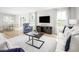 Open-concept living room leading to the dining area, providing an inviting and spacious atmosphere at 133 Cavalier Rider Run, Wendell, NC 27591