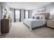 Calm main bedroom featuring soft lighting, neutral colors, and cozy furniture at 133 Cavalier Rider Run, Wendell, NC 27591