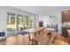 A dining area features a large wooden table, bench seating, and sliding glass doors to the patio at 140 Winsome Ln, Chapel Hill, NC 27516