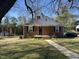 Charming brick home with a covered porch and well-maintained front yard at 1411 Hudson Ave, Durham, NC 27705