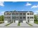 Attractive new construction townhomes showcasing varied siding colors, single garages, and professionally landscaped front yards at 1510 Indigo Creek Dr, Zebulon, NC 27597