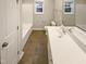 This bathroom features a single sink vanity, and a shower and tub combo at 157 W Copenhaver Dr, Clayton, NC 27527