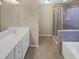 This bathroom includes double vanity sinks, a shower, and bathtub at 157 W Copenhaver Dr, Clayton, NC 27527