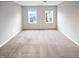 This is a standard bedroom with two windows that overlooks the neighborhood with grey walls at 157 W Copenhaver Dr, Clayton, NC 27527