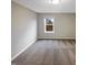 This bedroom has a single window that offers a lot of natural light and neutral colored walls at 157 W Copenhaver Dr, Clayton, NC 27527
