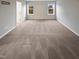 This carpeted bedroom features neutral paint colors and lots of natural light at 157 W Copenhaver Dr, Clayton, NC 27527