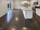 This kitchen features stainless steel appliances, white cabinets, a kitchen island, and hardwood floors at 157 W Copenhaver Dr, Clayton, NC 27527