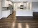 This kitchen features stainless steel appliances, white cabinets, and a kitchen island at 157 W Copenhaver Dr, Clayton, NC 27527