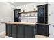 Close up shot of the bar in the basement highlighting custom shelving and stone backsplash at 1600 Sweetwater Ln, Raleigh, NC 27610