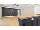 View of the basement bar area featuring wood countertop and unique wall design at 1600 Sweetwater Ln, Raleigh, NC 27610