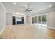 Spacious finished basement featuring hardwood floors, a wet bar, and access to a screened in patio at 1600 Sweetwater Ln, Raleigh, NC 27610
