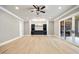 Finished basement featuring a bar with custom shelving and a walkout patio with fireplace at 1600 Sweetwater Ln, Raleigh, NC 27610