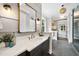Luxurious bathroom with a modern vanity, stylish mirror, and glass enclosed shower in the background at 1600 Sweetwater Ln, Raleigh, NC 27610