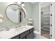 Stylish bathroom showcasing marble countertops, vessel sink, bronze fixtures, and decorative mirror at 1600 Sweetwater Ln, Raleigh, NC 27610