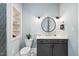Stylish half bathroom with a decorative tile floor and built-in shelving at 1600 Sweetwater Ln, Raleigh, NC 27610