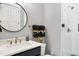 Beautiful bathroom with a round mirror, modern fixtures, and tiled shower at 1600 Sweetwater Ln, Raleigh, NC 27610