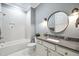 Bright bathroom featuring a tub and shower combo, and brushed gold fixtures at 1600 Sweetwater Ln, Raleigh, NC 27610