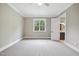 Bedroom with neutral carpeting and bathroom access, offering comfortable living space at 1600 Sweetwater Ln, Raleigh, NC 27610