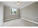 Empty bedroom features plush carpet, neutral walls, and natural light with window at 1600 Sweetwater Ln, Raleigh, NC 27610