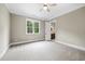 Spacious bedroom with neutral carpeting, natural lighting, and bathroom access at 1600 Sweetwater Ln, Raleigh, NC 27610
