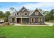 Charming two-story home featuring a beautifully landscaped yard and a welcoming covered porch at 1600 Sweetwater Ln, Raleigh, NC 27610
