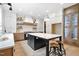 Modern kitchen with an island, pendant lighting, stainless steel appliances and custom cabinets at 1600 Sweetwater Ln, Raleigh, NC 27610