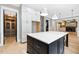 This open concept kitchen has a large center island, modern lighting, and direct access to the formal dining room at 1600 Sweetwater Ln, Raleigh, NC 27610