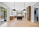 Spacious, modern kitchen with an island, stylish pendant lighting, and stainless steel appliances at 1600 Sweetwater Ln, Raleigh, NC 27610