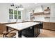 This spacious kitchen features an island with a white countertop and modern appliances, perfect for cooking and entertaining at 1600 Sweetwater Ln, Raleigh, NC 27610