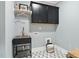 This laundry room has modern cabinets and a utility sink with black and white patterned floors at 1600 Sweetwater Ln, Raleigh, NC 27610