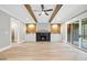 Large living room with wood beam ceilings, fireplace, built in cabinets and hardwood floors at 1600 Sweetwater Ln, Raleigh, NC 27610