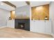 Close up of living room with wood beam ceilings, fireplace, built in cabinets and hardwood floors at 1600 Sweetwater Ln, Raleigh, NC 27610