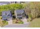 Aerial view of a two-story home with a manicured front lawn and a two-car garage at 1680 Mint River Dr, Apex, NC 27502