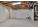 Unfinished basement with cement floor and exposed ceiling with fixtures at 1680 Mint River Dr, Apex, NC 27502