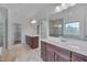 Bathroom featuring dual vanities, framed mirrors, and a glass enclosed shower and tub at 1680 Mint River Dr, Apex, NC 27502
