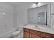 Neutral bathroom boasts a vanity, bathtub, and large mirror at 1680 Mint River Dr, Apex, NC 27502