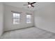 Well-lit bedroom showcasing neutral walls, carpeted floors, and a ceiling fan at 1680 Mint River Dr, Apex, NC 27502