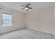 Bright bedroom showcasing neutral walls, carpeted floors, and a ceiling fan at 1680 Mint River Dr, Apex, NC 27502