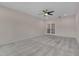 Expansive bedroom showcasing neutral walls, carpeted floors, and French doors at 1680 Mint River Dr, Apex, NC 27502