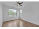 Empty bedroom with wood floors, ceiling fan, and natural light from the windows at 1680 Mint River Dr, Apex, NC 27502