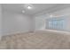 Spacious bonus room features neutral carpet, recessed lights, and natural light at 1680 Mint River Dr, Apex, NC 27502
