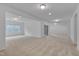 Large bonus room features neutral carpet, recessed lighting, and a sliding glass door at 1680 Mint River Dr, Apex, NC 27502