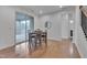 Dining area with wood floors and sliding glass doors to screened in porch at 1680 Mint River Dr, Apex, NC 27502